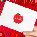 Load image into Gallery viewer, This image shows the personalized school sticker on the back of an envelope.
