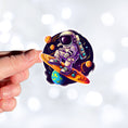 Load image into Gallery viewer, This image show a hand holding the astronaut surfing sticker