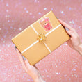 Load image into Gallery viewer, This image shows the valentine sticker on a package.