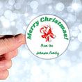 Load image into Gallery viewer, This image shows a hand holding the Personalized Holiday Stickers - Candy Cane Christmas.