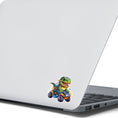 Load image into Gallery viewer, This image shows the dino on ATV sticker on the back of an open laptop.