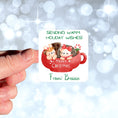 Load image into Gallery viewer, This image shows the personalized holiday sticker being held on one finger over a background of bubbles.