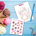 Load image into Gallery viewer, This image shows the Chibi Sloth notepad with a sample pen (pen colors are randomly selected to complement each note pad), and the included sticker sheet as part of the Animals with Ice Cream Notepads.