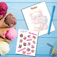 Load image into Gallery viewer, This image shows the Chibi Bear notepad with a sample pen (pen colors are randomly selected to complement each note pad), and the included sticker sheet as part of the Animals with Ice Cream Notepads.
