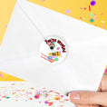 Load image into Gallery viewer, This image shows the back of an envelope with the "You're invited" sticker applied.