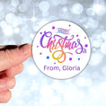 Load image into Gallery viewer, This image shows a hand holding the Personalized Holiday Stickers - Merry Christmas Purple.