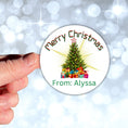 Load image into Gallery viewer, This image shows a hand holding the Personalized Holiday Stickers - Merry Christmas Tree.