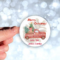 Load image into Gallery viewer, This image shows the personalized holiday sticker being held on one finger over a background of bubbles.