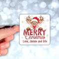 Load image into Gallery viewer, This image shows a hand holding the Personalized Holiday Stickers - Merry Reindeer.