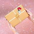 Load image into Gallery viewer, This image shows the valentine sticker on a package.