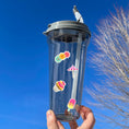 Load image into Gallery viewer, This image shows a water bottle with some of the Picnic stickers applied.
