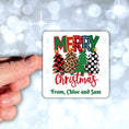 Load image into Gallery viewer, This image shows a hand holding the Personalized Holiday Stickers - Plaid Christmas.