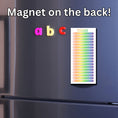 Load image into Gallery viewer, This image shows the Tasks Notepad - Rainbow Prism on the front of a refrigerator.