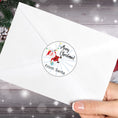 Load image into Gallery viewer, This image shows the Personalized Holiday Stickers - Santa Merry Christmas on the back of an envelope.