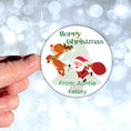Load image into Gallery viewer, This image shows a hand holding the Personalized Holiday Stickers - Santa & Reindeer.