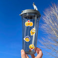Load image into Gallery viewer, This image shows a water bottle with some of the Smiley stickers applied.
