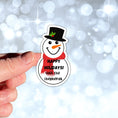 Load image into Gallery viewer, This image shows the personalized holiday sticker being held on one finger over a background of bubbles.