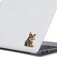 Load image into Gallery viewer, This image shows the steampunk puppy sticker on the back of an open laptop.