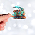 Load image into Gallery viewer, This image shows a hand holding the toy train sticker.