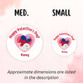 Load image into Gallery viewer, This image shows medium and small personalized valentine stickers next to each other as a size comparison.
