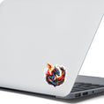 Load image into Gallery viewer, This image shows the Baby Dragon in a Nest Die-Cut Sticker on the back of an open laptop.