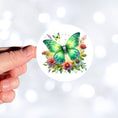 Load image into Gallery viewer, This image shows a hand holding the Green Moth die cut sticker.