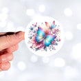 Load image into Gallery viewer, This image shows a hand holding the Blue and Pink Butterfly with Stars Die-Cut Sticker.