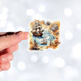 Load image into Gallery viewer, This image shows a hand holding the Pirate Ship Map Die-Cut Sticker