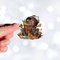Load image into Gallery viewer, This image shows a hand holding the Pirate Treasure 1 Die-Cut Sticker.