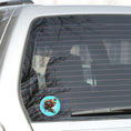 Load image into Gallery viewer, This image show the steampunk bronzed flower on the back window of a car.