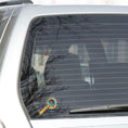 Load image into Gallery viewer, This image shows the steampunk ladybug sticker on the back window of a car.