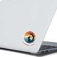 Load image into Gallery viewer, Hang 10 Bro! Catch a wave with this individual die-cut sticker featuring the silhouette of a male surfer inside the tube, all on a colored gradient background. Cowabunga! This image shows the Catching a Wave sticker on the back of an open laptop.