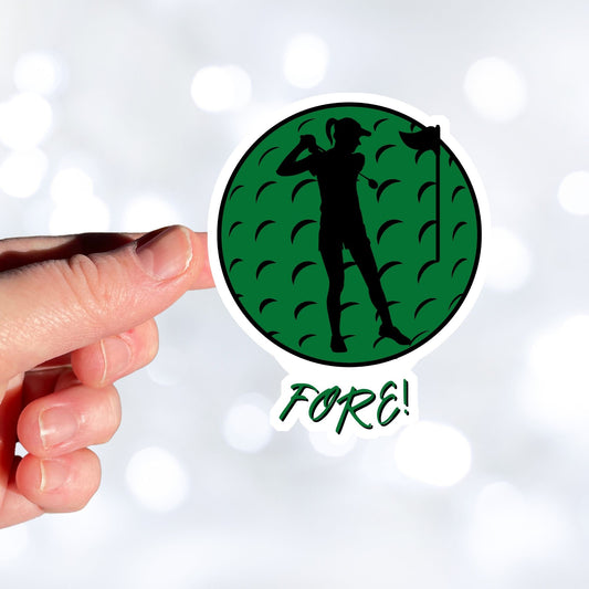 Show your love of golf with this individual die-cut sticker! This sticker shows the silhouette of a golfer with a ponytail about to swing, on a green golf ball background, with the word "Fore!" below. This image shows a hand holding the golf sticker.