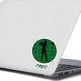 Load image into Gallery viewer, Show your love of golf with this individual die-cut sticker! This sticker shows the silhouette of a golfer with a ponytail about to swing, on a green golf ball background, with the word "Fore!" below. This image shows the golf sticker on the back of an open laptop.