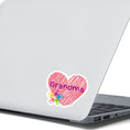 Load image into Gallery viewer, Show how much you love grandma with this individual die-cut sticker. This makes a great gift for grandma, or for all grandma's to proudly show they are a grandmother! This sticker features a red scribbled heart with Grandma written across the middle and 5 small paint hands on the lower left side. This image shows the Grandma sticker on the back of an open laptop.