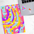 Load image into Gallery viewer, Groovy man! This psychedelic sticker sheet is filled with images of rainbows, mushrooms, flowers, a smiley face, and even a VW Microbus! This image shows the sticker sheet next to an open laptop with stickers of a smiling purple and teal flower and an orange and purple topped mushroom applied below the keyboard.