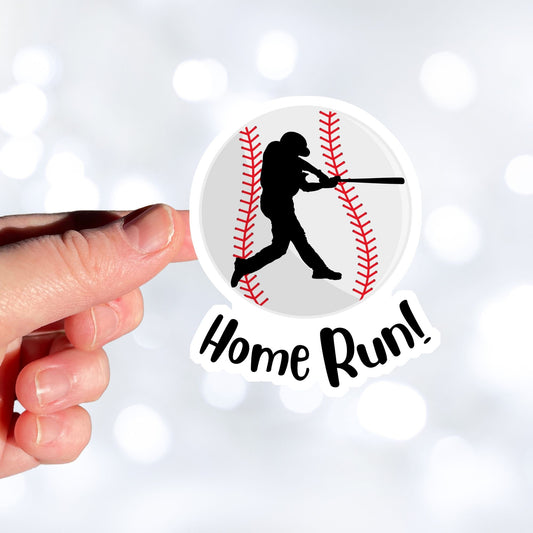 Knock it out of the park! This individual die-cut sticker features the silhouette of a baseball player swinging a bat, on a background of a baseball, with the word "Homerun!" below. This image shows a hand holding the baseball sticker.