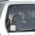 Load image into Gallery viewer, Float away on a colorful hot air balloon! This individual die-cut hot air balloon sticker has six, yes six, different hot air balloons on a background of clouds. This image shows the hot air balloon die-cut sticker on the back window of a car.