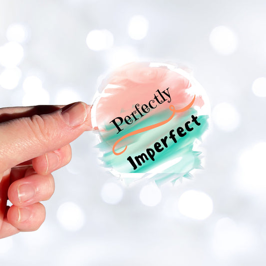 When you think about it, we're ALL Perfectly Imperfect! This inspirational die-cut sticker features the words Perfectly Imperfect on a cloudy pastel background. Check out our Inspirational collection for more inspiring stickers! This image shows a hand holding the Perfectly Imperfect sticker.