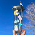 Load image into Gallery viewer, Mermaids, rainbows, and unicorns; it's our Magical World sparkle sticker sheet! This sticker sheet is filled with fun and cute magical images, and it has a sparkle overlay so it glitters in the light! This image is of a water bottle with two different unicorn stickers, a mermaid sticker, an octopus sticker, and a small smiling star sticker.