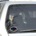 Load image into Gallery viewer, Guys, want to celebrate your man cave? Then this individual die-cut sticker is just what you need! It features a black background with neon images of "Man Cave" written above a football, clinking bottles, and slice of pizza. What more could you want? This image shows the Man Cave sticker on the back window of a car.