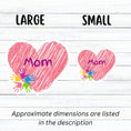 Load image into Gallery viewer, Show how much you love your mom with this individual die-cut sticker. This makes a great gift for mom, or for all mom's to proudly show they are a mother! This sticker features a pink scribbled heart with Mom written across the middle and 5 small paint hands on the lower left side. This image shows large and small Mom stickers next to each other.