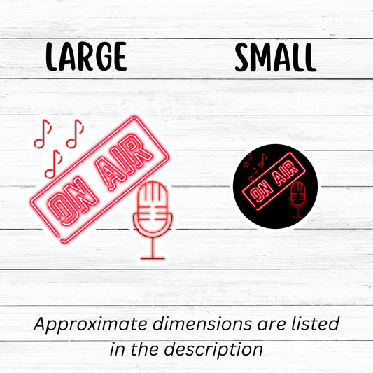 Music, TV, Podcast, or even Amateur Radio - this sticker is great for anyone who is On Air! This individual die-cut sticker is in neon red with the words On Air above a microphone with music notes above. Please note that the large version of this sticker is on a white background and cut around the image, and the small version is on a black circle. This image shows the large and small On Air stickers next to each other.