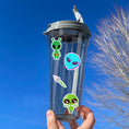 Load image into Gallery viewer, This sticker sheet is out of this world with individual stickers of aliens, space ships, planets, and alien creatures. This image is of a water bottle with some of the individual stickers on it