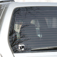 Load image into Gallery viewer, If you think a pirate's life is for you, then this individual die-cut sticker is just what you need! This pirate's life sticker features a jolly rodger (skull and crossed swords) flag with storm clouds and the saying "A Pirate's Life For Me". This image shows the pirate's life sticker on the back window of a car.