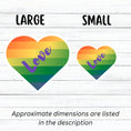 Load image into Gallery viewer, This individual die-cut sticker features a heart shape with graduated colors from orange at the top to blue at the bottom, and the word love written across. Perfect for the people you love! This image shows large and small Love Heart die-cut stickers next to each other.