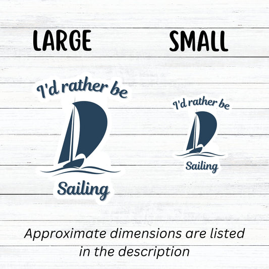 This individual die-cut sticker is great for anyone who loves to sail! It features a blue sailboat with the words "I'd rather be Sailing". This sailing sticker is understated, but says a lot! This image shows large and small I'd rather be Sailing stickers next to each other.