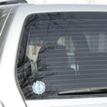Load image into Gallery viewer, Sing like nobody's listening; dance like nobody's watching. This blue, gray, and white individual die-cut sticker features someone singing in the shower. This image shows the Sing like nobody's listening die-cut sticker on the back window of a car.