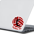 Load image into Gallery viewer, Show your love of volleyball with this individual die-cut sticker! This sticker shows the silhouette of a player with a ponytail about to spike the ball, on a maroon and white volleyball background, with the words "Spike it!" below. This image shows the volleyball sticker on the back of an open laptop.