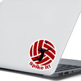 Load image into Gallery viewer, Show your love of volleyball with this individual die-cut sticker! This sticker shows the silhouette of a player about to spike the ball, on a maroon and white volleyball background, with the words "Spike it!" below. This image shows the volleyball sticker on the back of an open laptop.